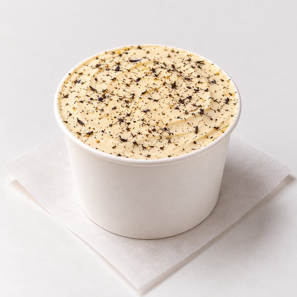 Earl grey and dulce de leche tiramisu cup topped with earl grey tea flowers, from bōm dough in Cambridge, MA.