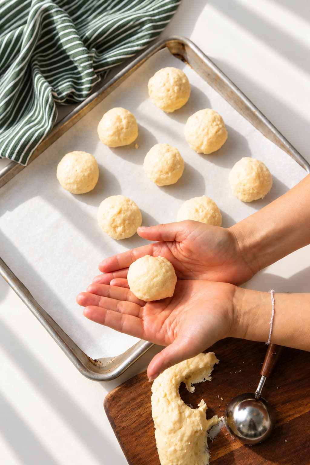 bōm dough pão de queijo — shaped by hand, Cambridge, MA Pão de queijo — Brazilian cheese bread — shaped by hand on a baking tray at bōm dough in Cambridge, MA.