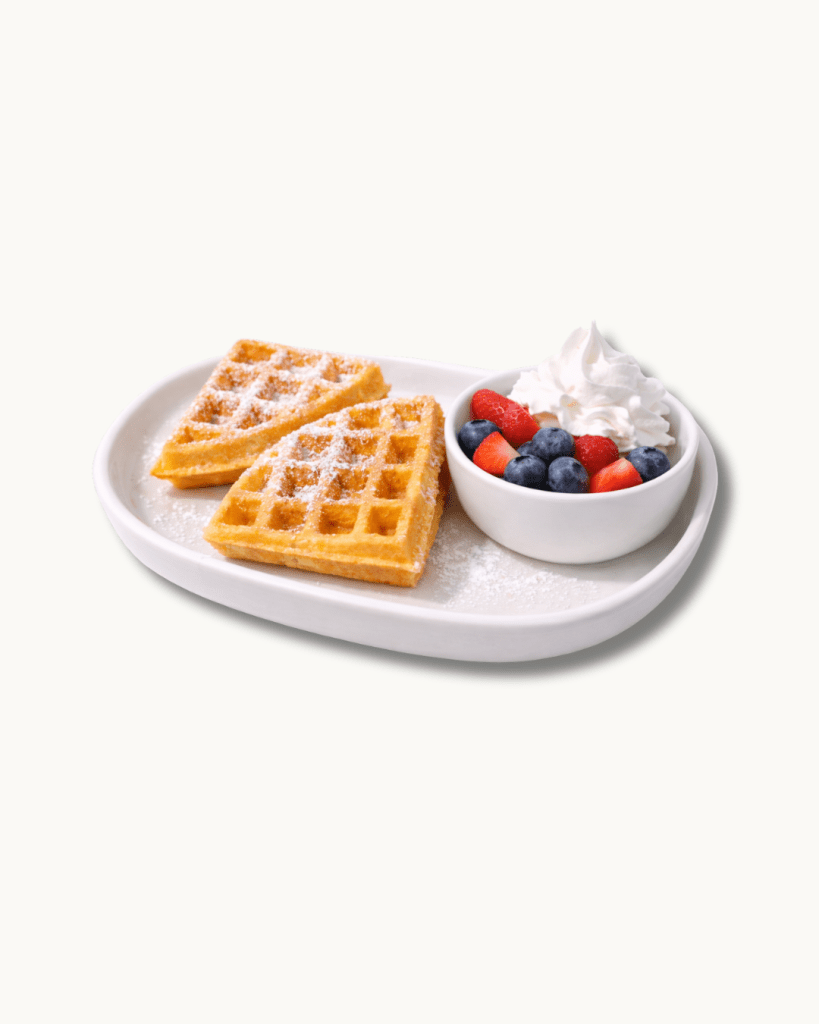 naturally gluten-free mochi waffles topped with fresh berries and cream, a signature breakfast offering at bôm dough.
