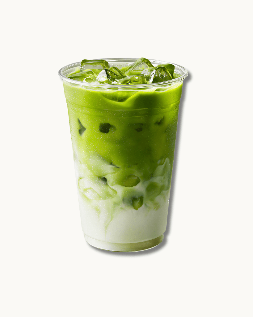 premium ceremonial grade iced strawberry matcha latte in a clear glass, part of the bôm dough drink program in cambridge.